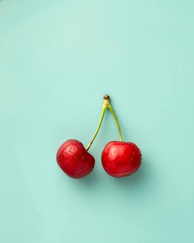 Glistening water-kissed ripe cherries with stems