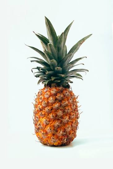 Golden pineapple crown showing textured aromatic scales